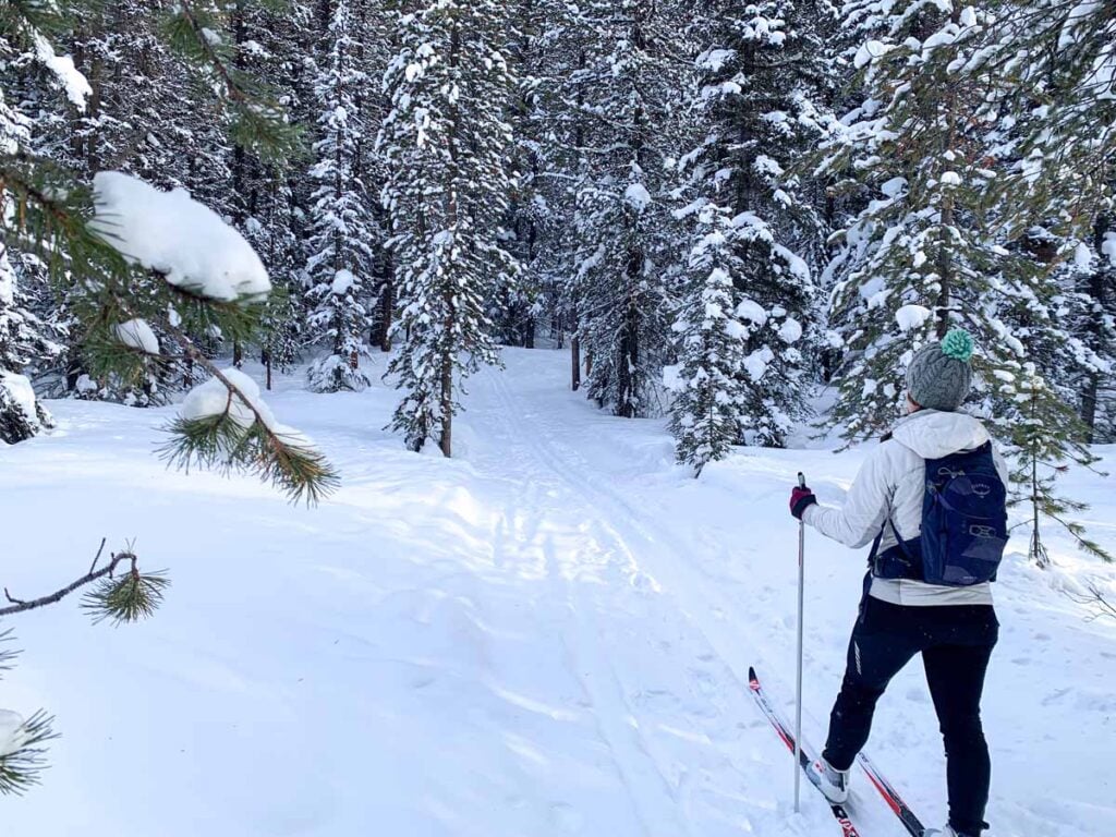 Celine Brewer, host of the Banff Travel Podcast, cross country skis on the Pipestone Loop near Lake Louise.