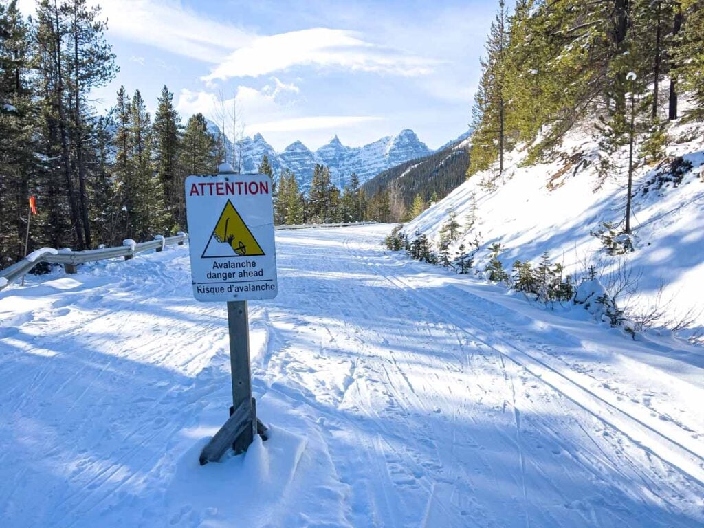 An avalanche warning sign on Moraine Lake Road signals the end of the cross-country ski trail.