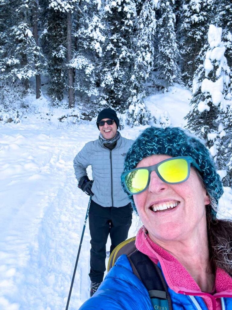 Dan and Celine Brewer are dressed in layers while cross country skiing in Banff National Park.