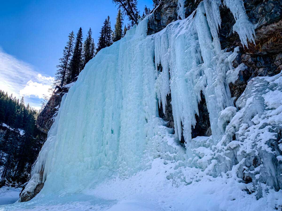 the many colors in the ice are why this large frozen waterfall in Kananaskis is called the Green Monster
