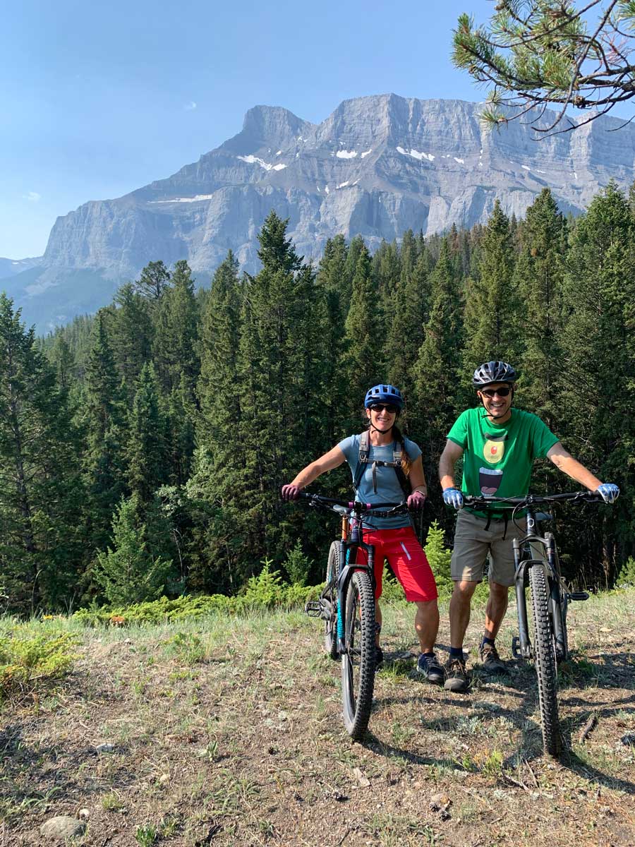 Couple mountain biking in Banff along tunnel trails