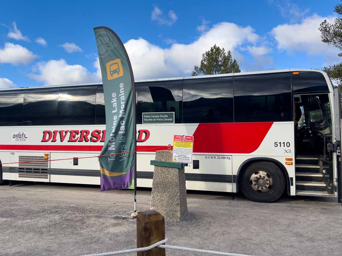Parks Canada Moraine Lake Shuttle Bus A Parks Canada shuttle bus to Moraine Lake is parked in the Lake Louise Ski Resort parking lot.