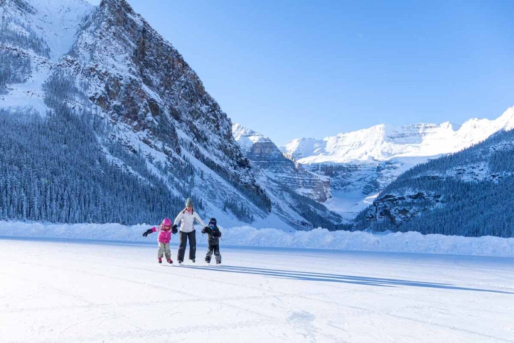 Celine Brewer and her kids enjoy ice skating on Lake Louise on a beautiful day in winter.