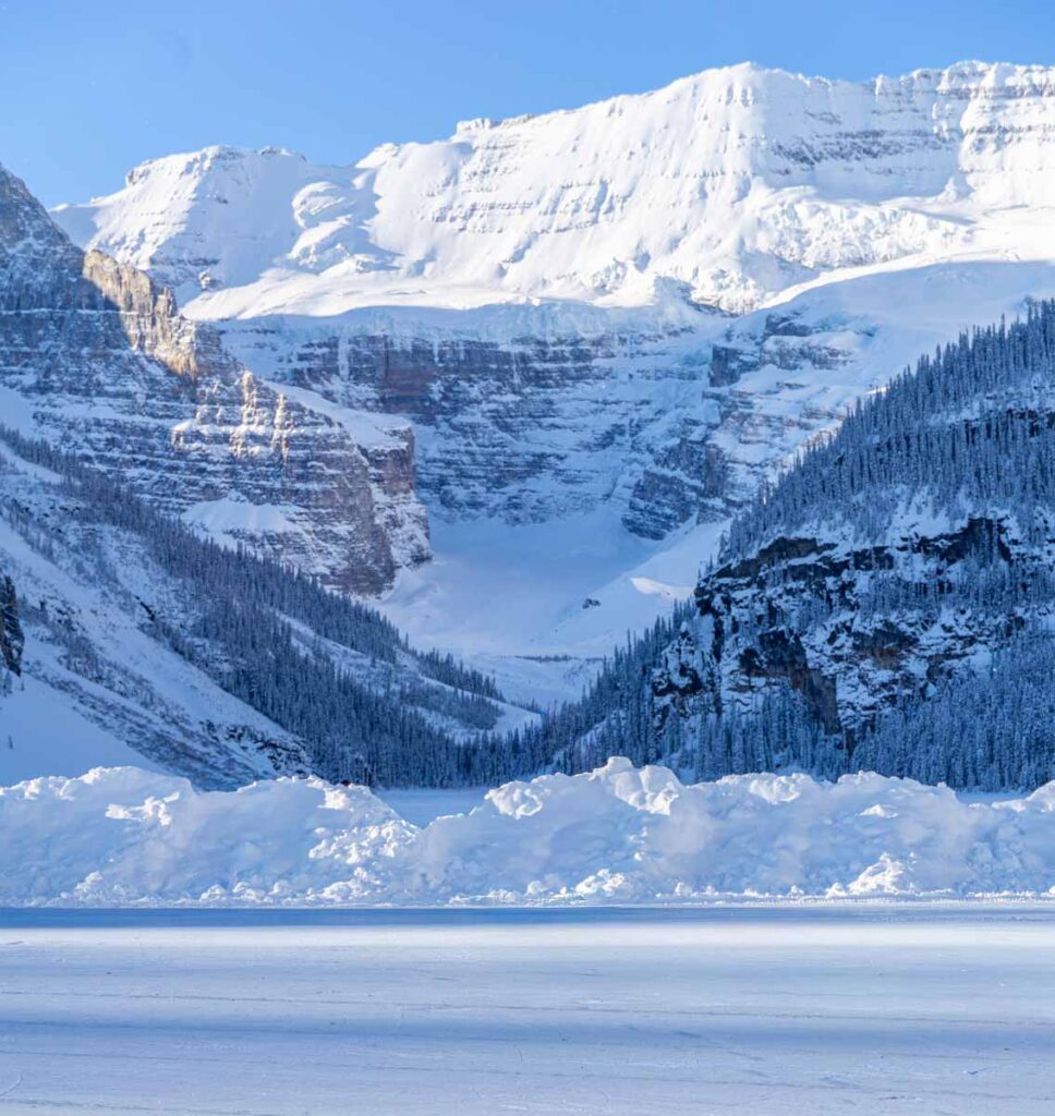 The Victoria Glacier seen across a frozen Lake Louise in winter.