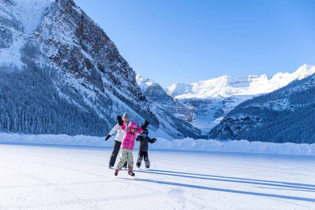 Celine Brewer, host of the Banff Travel Podcast, ice skating with the Brewer kids on frozen Lake Louise.
