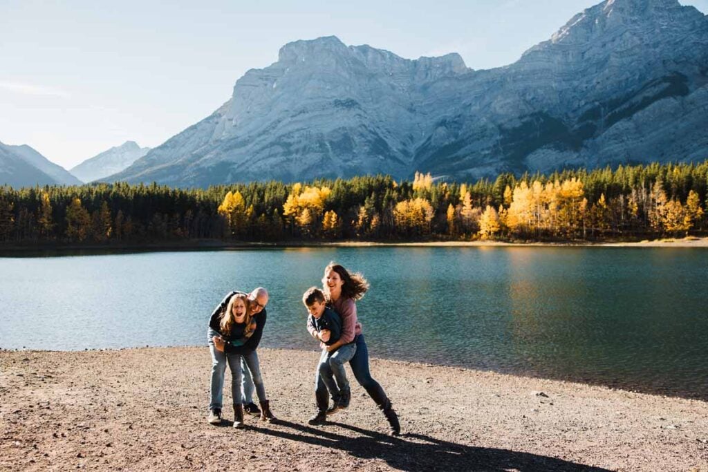 Dan and Celine Brewer, owners of TravelBanffCanada.com, play with their kids on a beautiful fall day at Wedge Pond in Kananaskis Country.