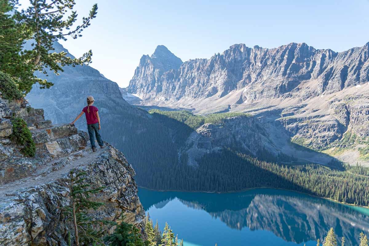A lone hiker on the Alpine Circuit enjoys the scenery from the Lake O'Hara hiking trails.