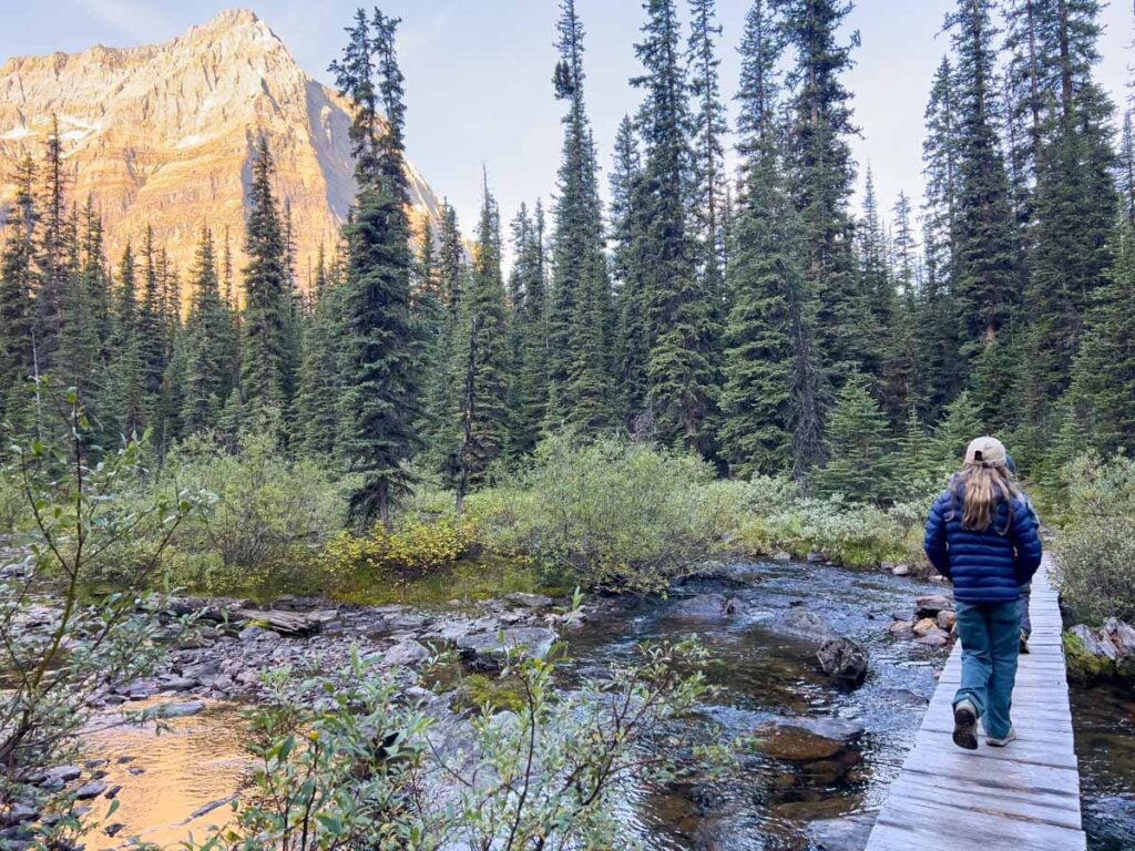 The Brewer kids, from the TravelBanffCanada.com blog, cross a stream on the Linda Lake hike while camping at Lake O'Hara.