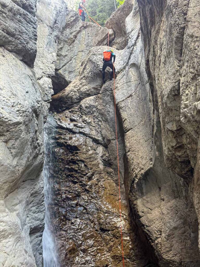 Dan Brewer rappels down a 15m waterfall on a canyoning tour at Hear Creek in Kananaskis Country.