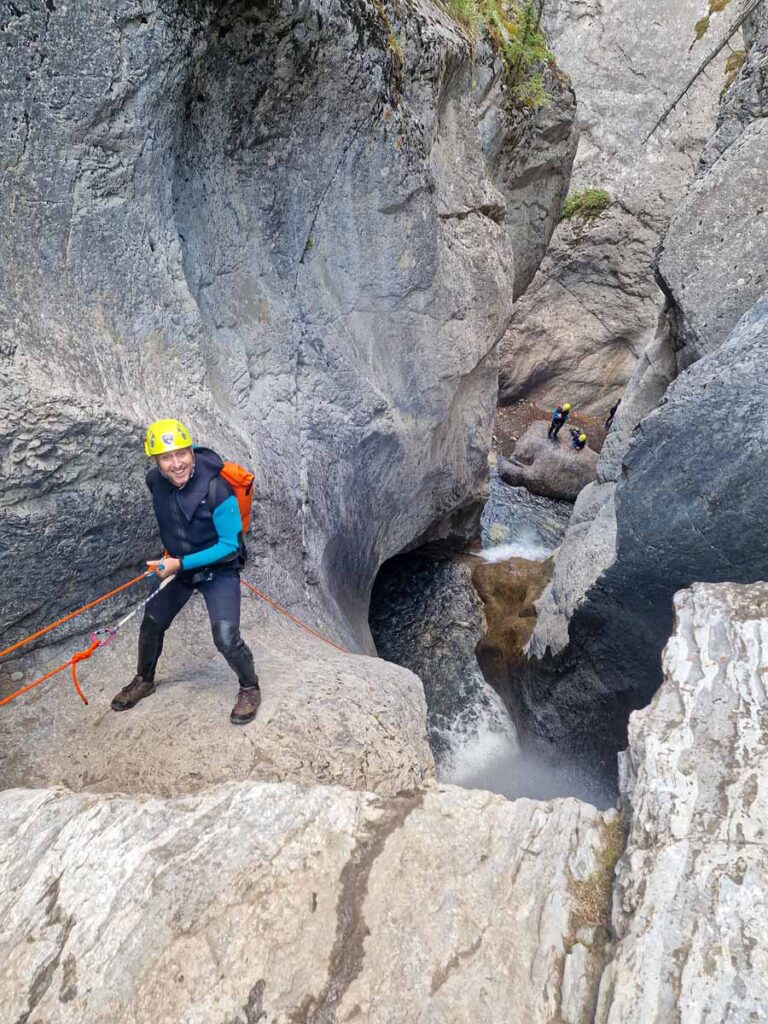 Dan Brewer, owner of TravelBanffCanada.com, rappels down a waterfall on the Heart Creek Canyoning Tour.