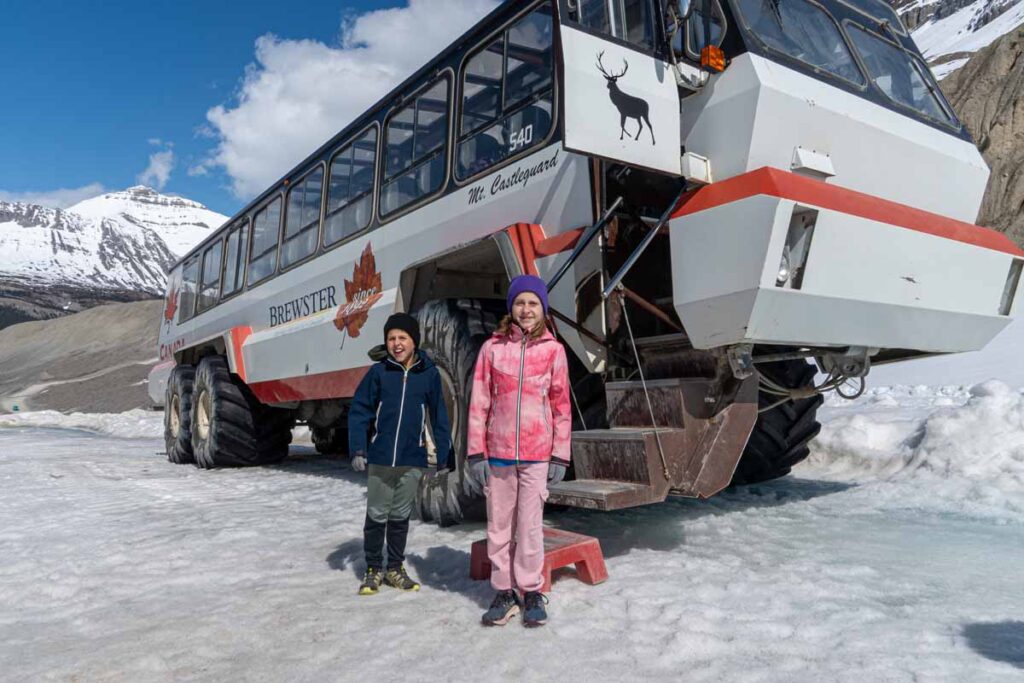 Two kids are properly dressed for the weather on the Columbia Icefields Adventure in Jasper.