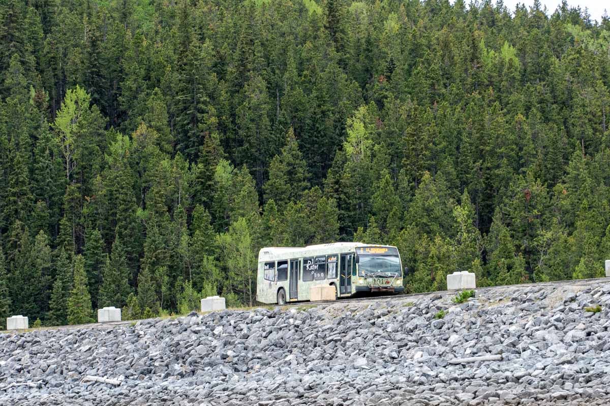 Roam Bus Route 6 - Lake Minnewanka Loop A Roam Route 6 public transit bus approaches Lake Minnewanka in Banff National Park.