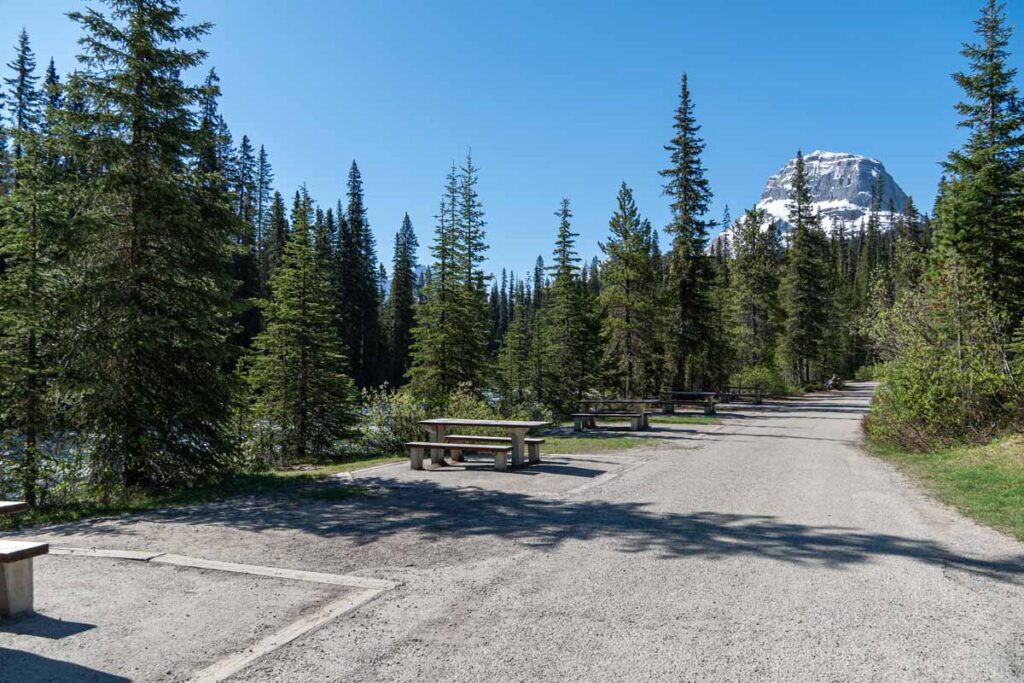 a line of picnic tables along the Yoho River at the Takakkaw Falls Day Use Area.