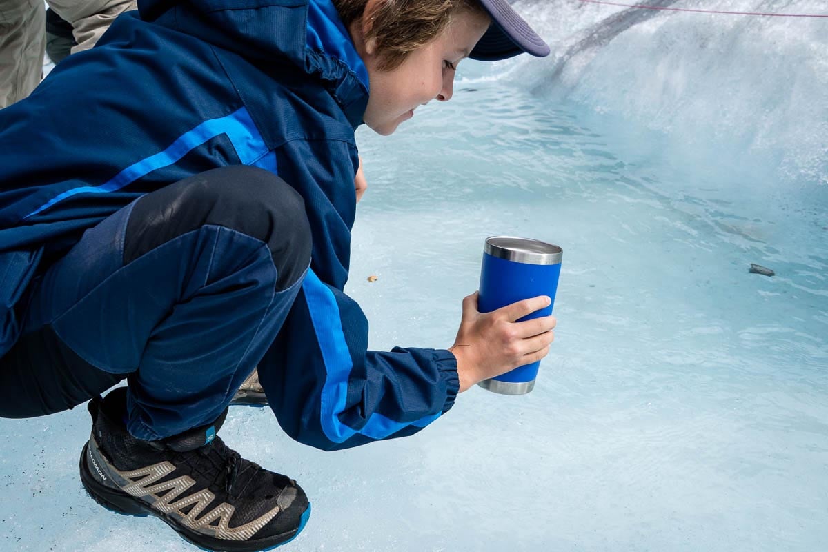 Glacier Water on Athabasca Glacier in Jasper Boy drinking glacier water at Athabasca Glacier in Jasper National Park