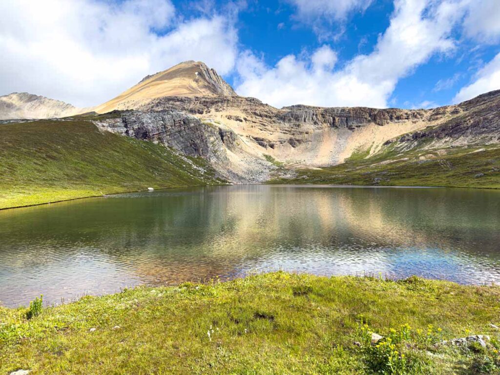 Cirque Peak reflects on the still water of Helen Lake in Banff National Park.