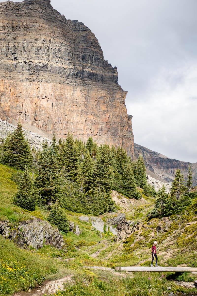 Helen Lake Trail - Banff Hiking Trails A girl crosses a bridge along the Helen Lake trail in Banff National Park