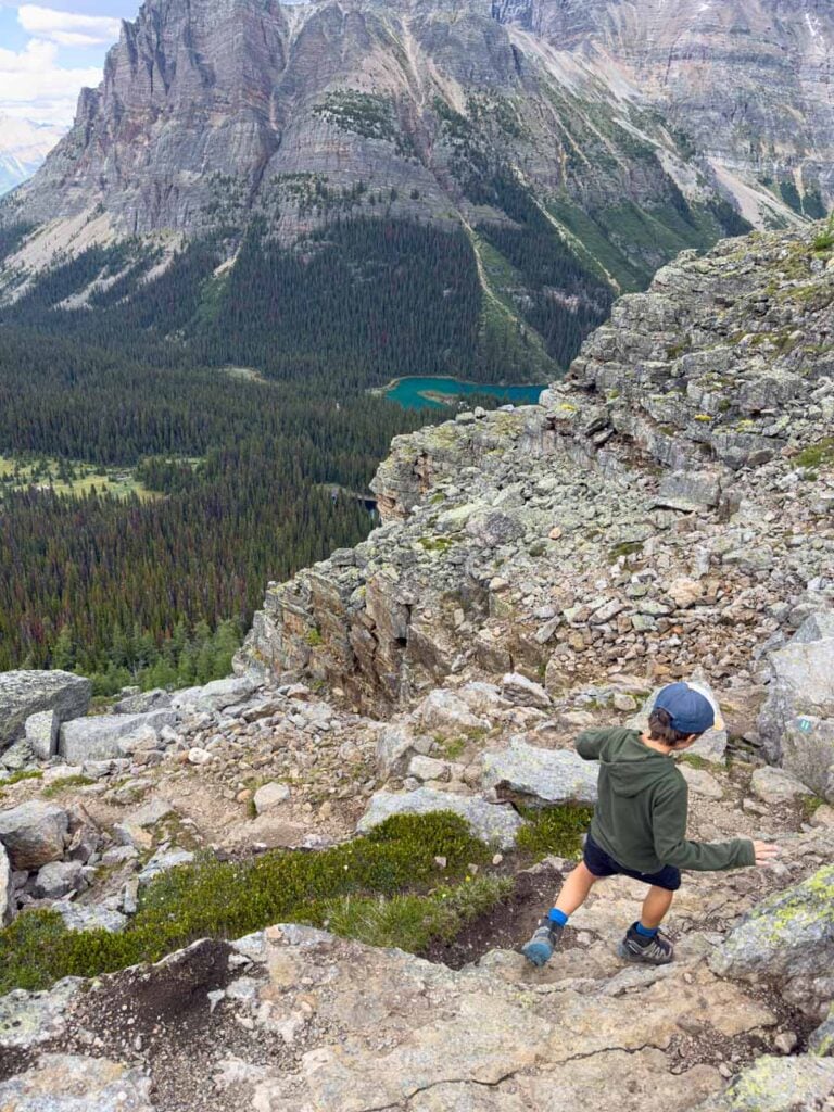 A 10-year old boy hikes carefully down the steep descent on the All Souls Prospect Trail at Lake O'Hara in Yoho National Park.