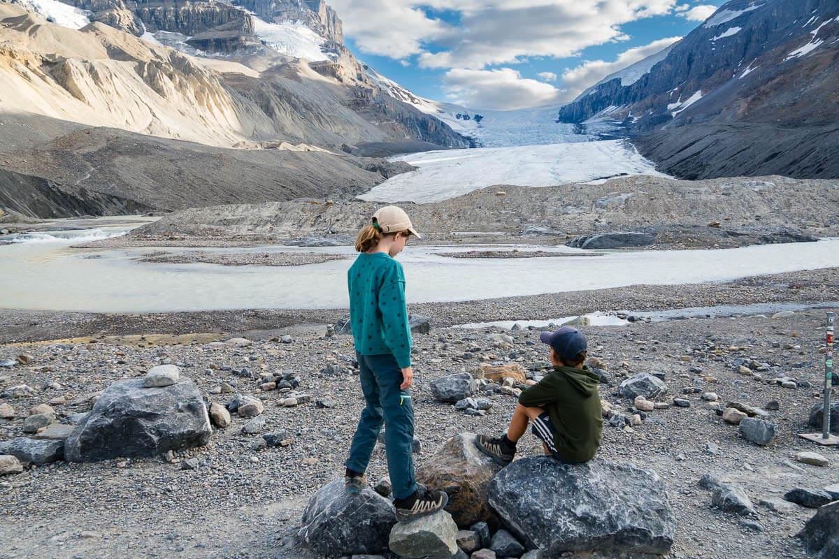 Toe of the Athabasca Glacier Hike Two kids look at Athabasca Glacier at the