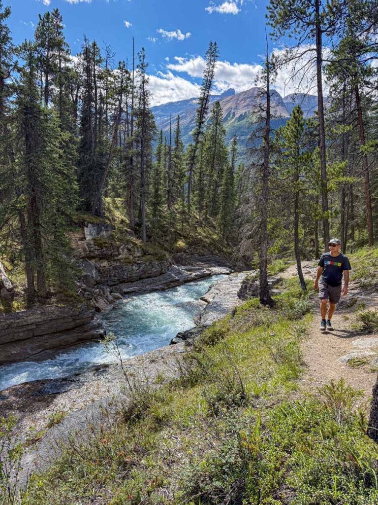 Dan Brewer, owner of TravelBanffCanada.com, walks next to Beauty Creek on the hike to Stanley Falls.