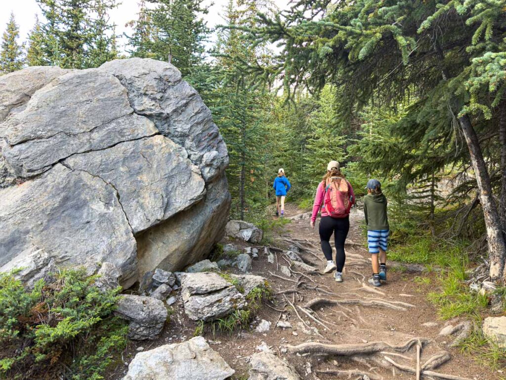 Celine Brewer, owner of TravelBanffCanada.com, hikes with her kids to the red chairs on Wilcox Pass.
