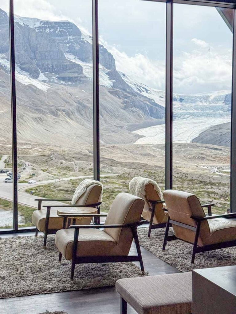 The stunning Moraine Lounge at the Glacier View Lodge features floor-to-ceiling windows with amazing views of the Athabasca Glacier.