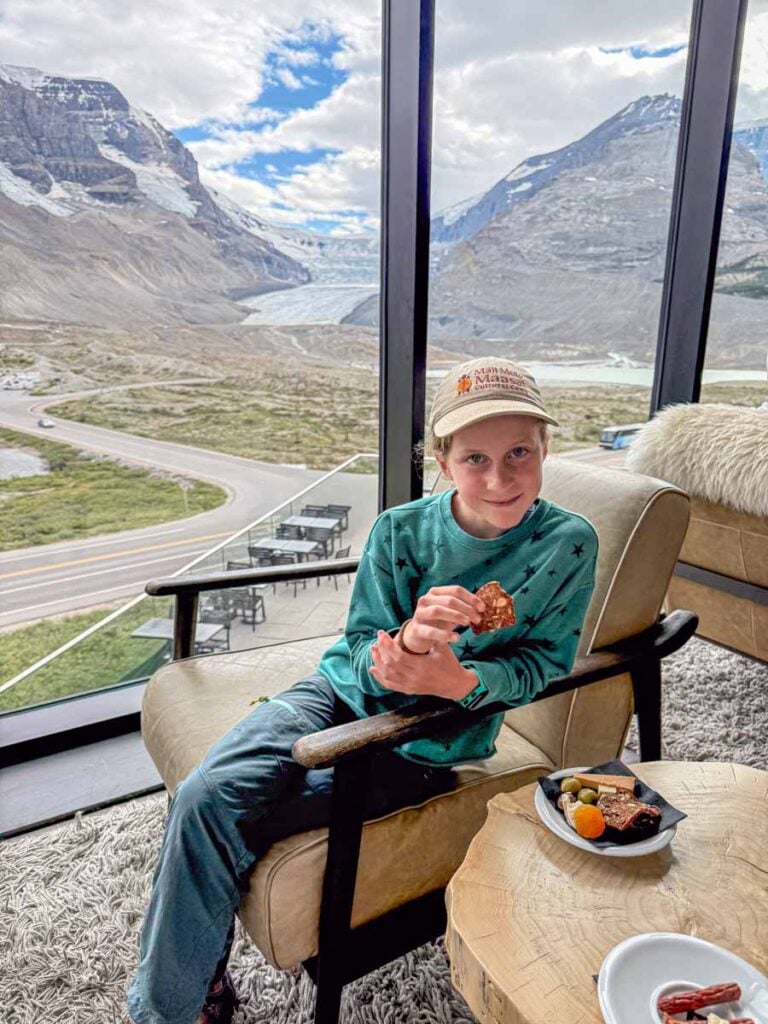 A 12-year old girl enjoys free charcuterie in the Moraine Lounge at the Glacier View Lodge in Jasper National Park.