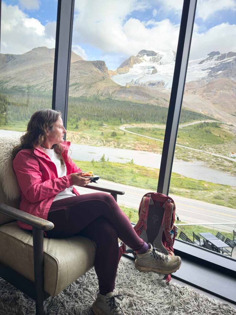 Celine Brewer, owner of the Travel Banff Canada blog, enjoys a complimentary drink and charcuterie in the Moraine Lounge at the Glacier View Lodge in Jasper.