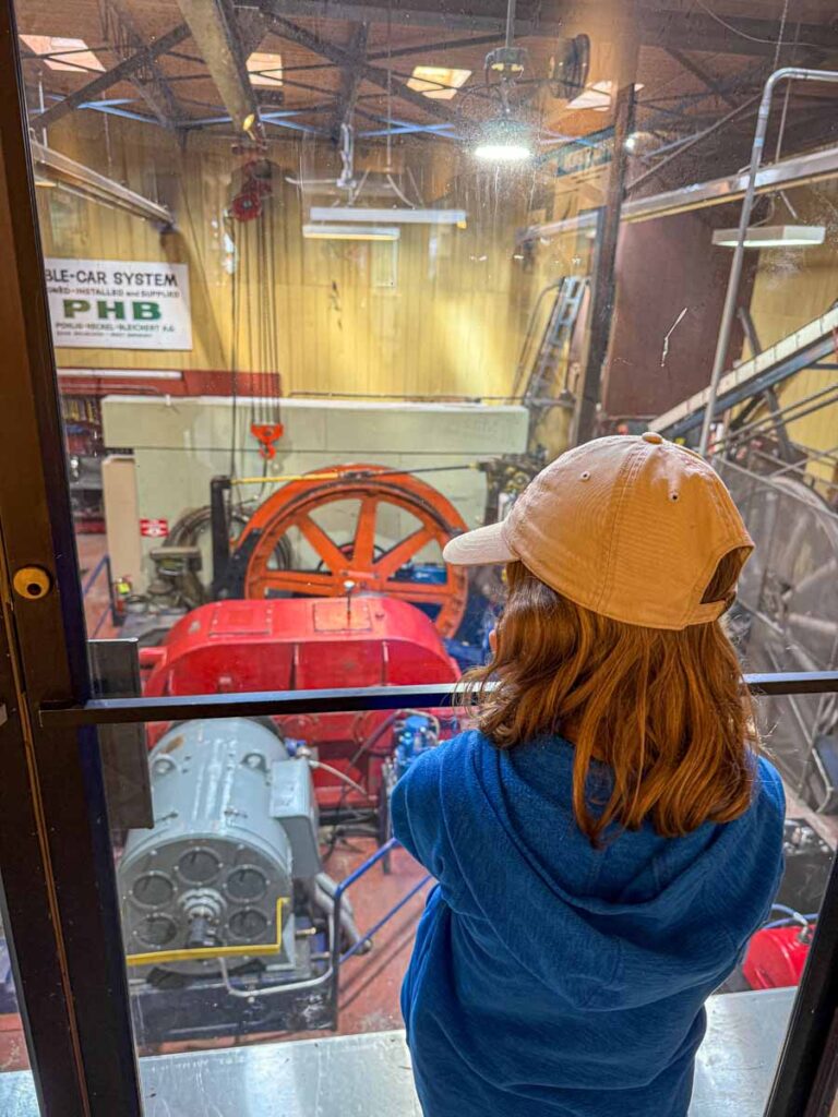 a 12-year old girl looks at the gears and cables which run the Jasper SkyTram.