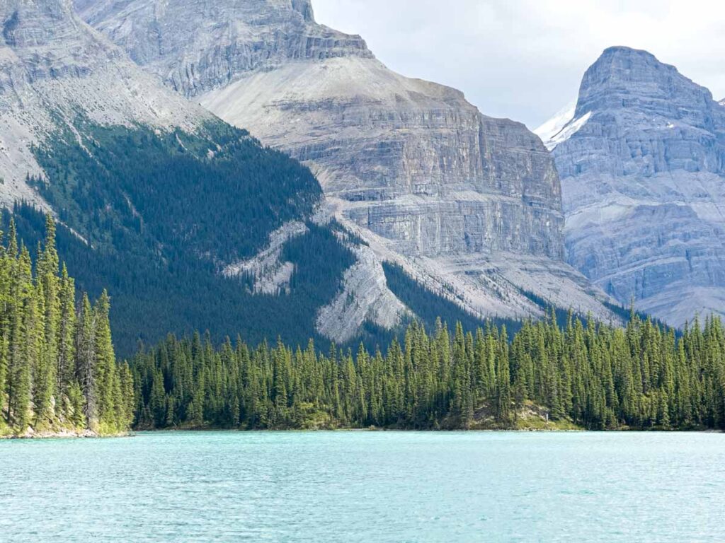 Dramatic mountains emerge from the water on Maligne Lake in Jasper National Park.