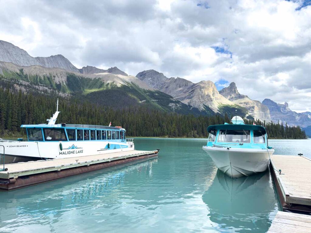 Two Maligne Lake Cruise boats are docked at Spirit Island.