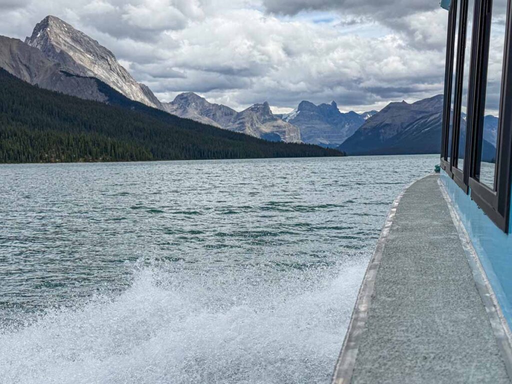 Spray from the Maligne Lake Cruise boat with stunning Rocky Mountain scenery.