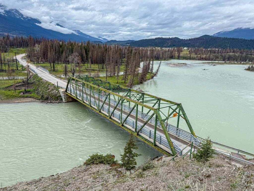 A charming green bridge over the Athabasca River seen from the Old Fort Point hike in Jasper.