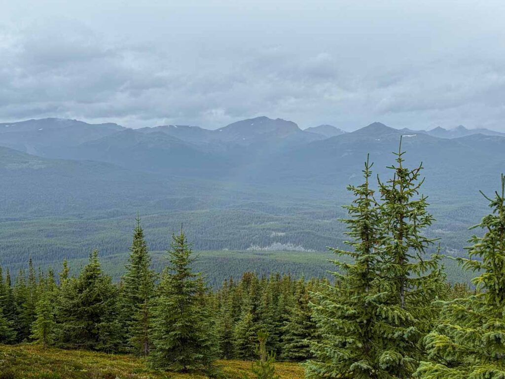 a rainbow appears over the Maligne Lake valley while hiking the Opal Hills Loops trail.