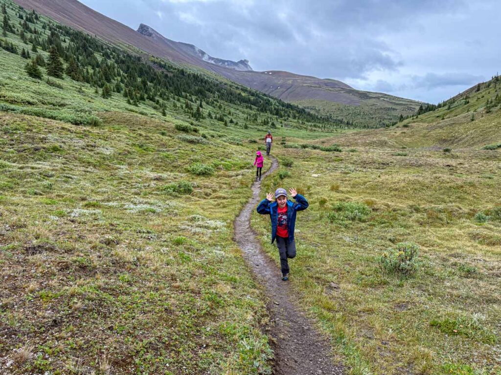 a 10-year old boy has some fun while enjoying a family hike on the Opal Hills Loop hike.