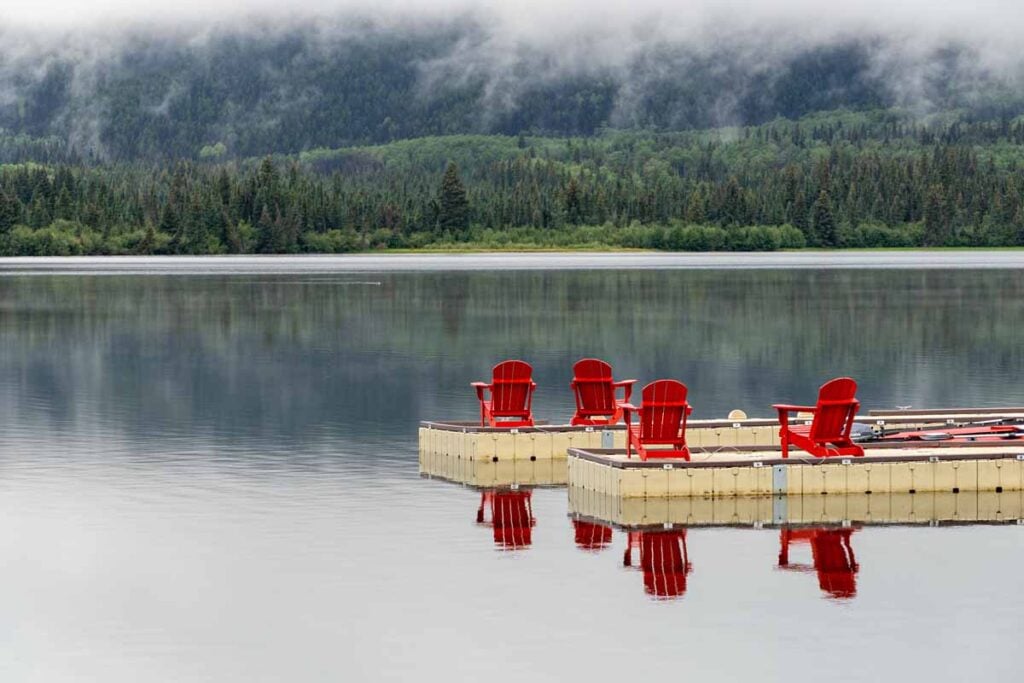 Bright red chairs on a dock at Pyramid Lake, Jasper National Park.