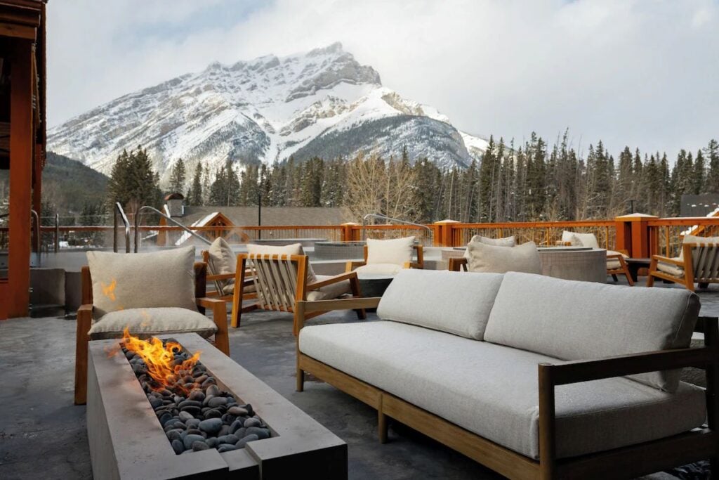 an outdoor fireplace in the rooftop lounge at the Otter Hotel in the Town of Banff.