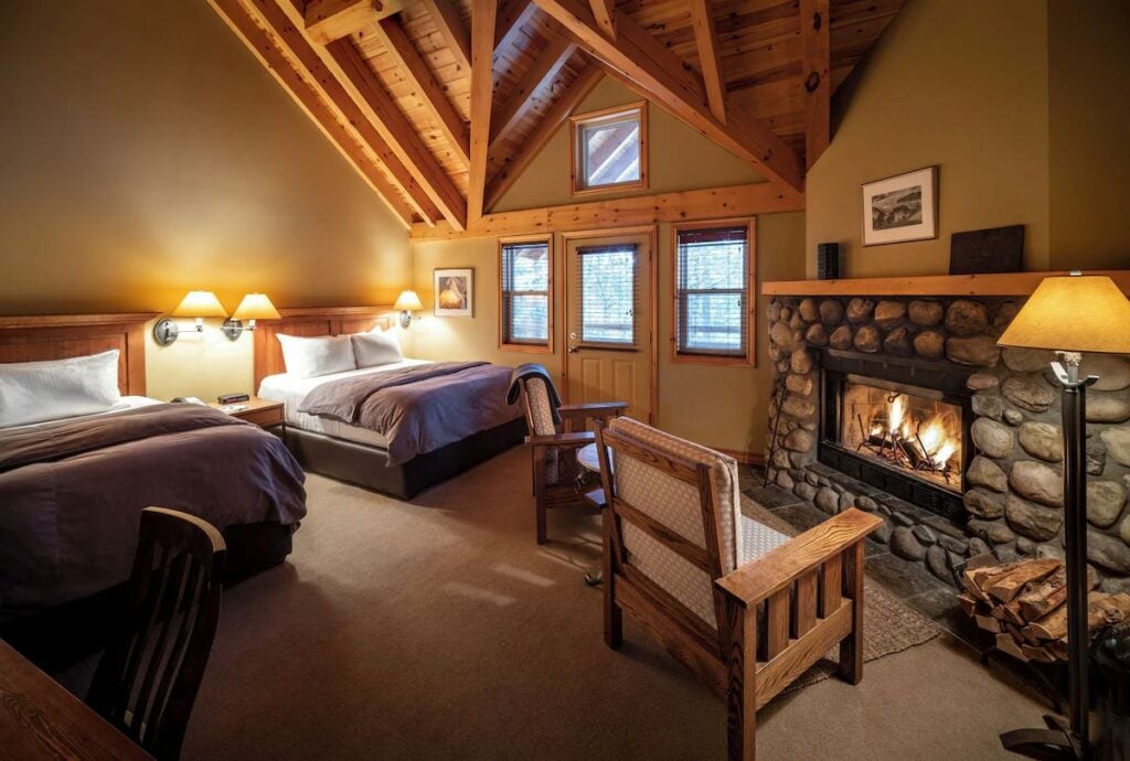 a cozy room with a wood burning fireplace at the Buffalo Mountain Lodge in Tunnel Mountain, Banff.