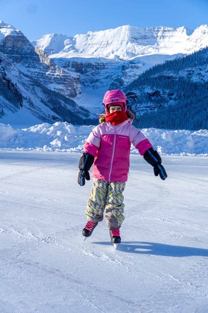 A Brewer child ice skates at Lake Louise on a beautiful winter day.