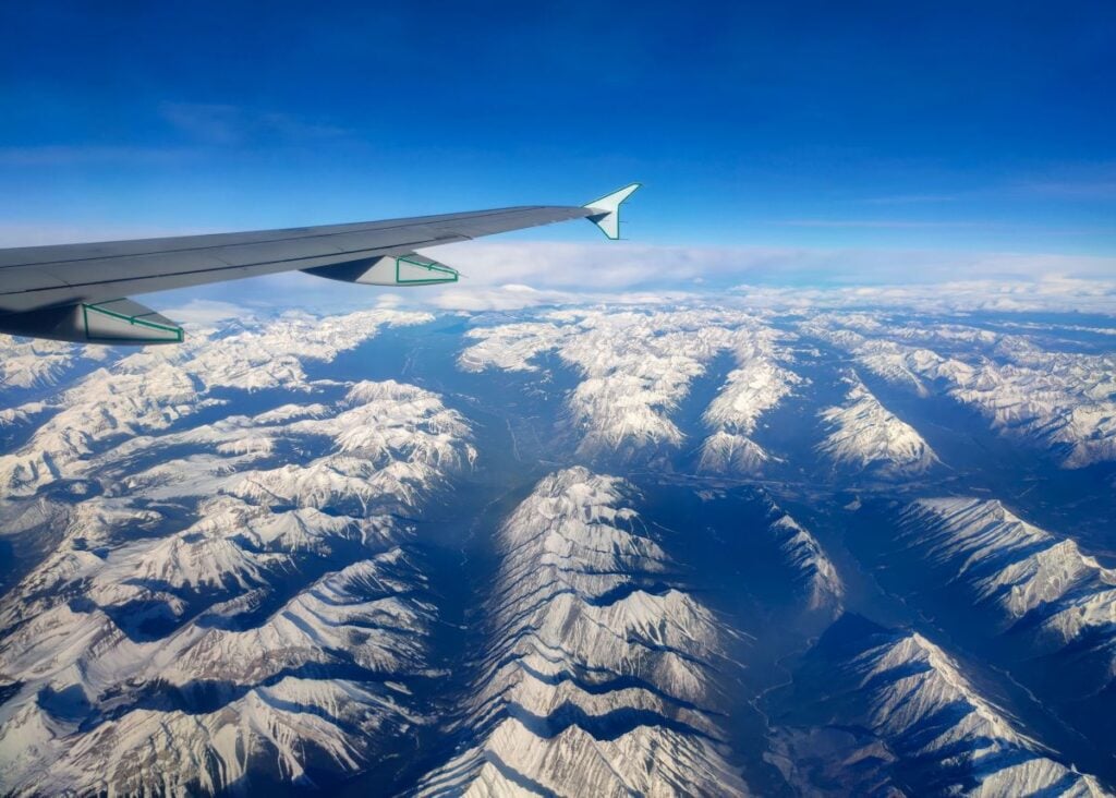 An airplane flies over Banff National Park, Canada.