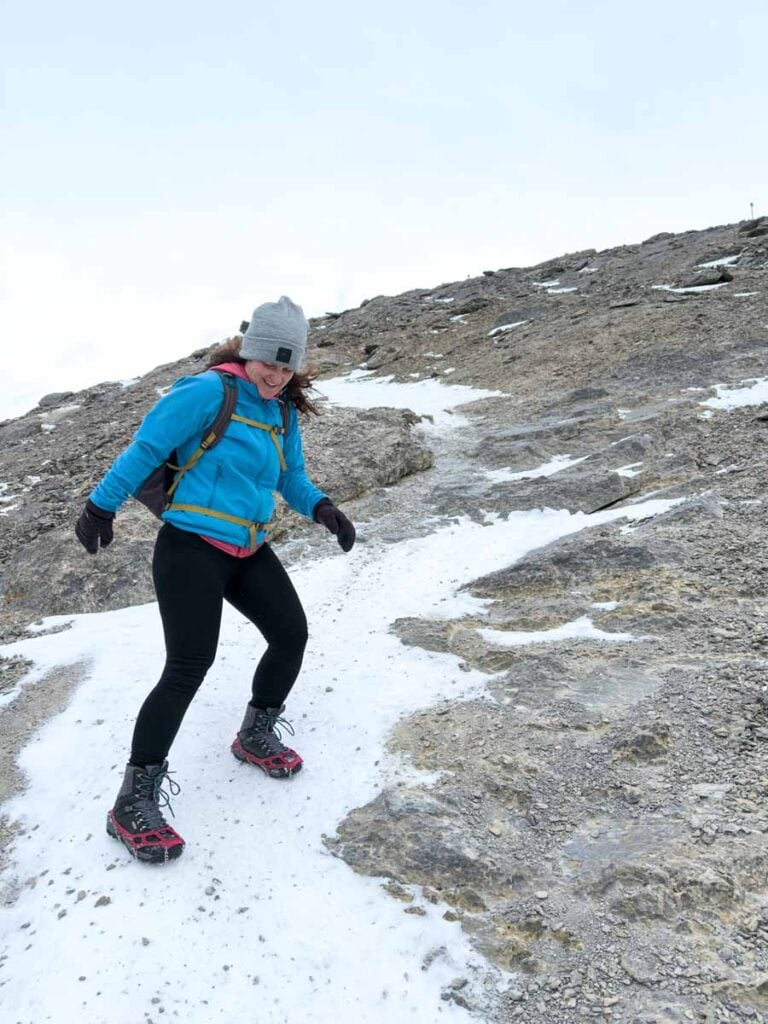 Celine Brewer, owner of TravelBanffCanada.com, wears MICROspikes during her descent from the summit of La Ling Peak in winter.