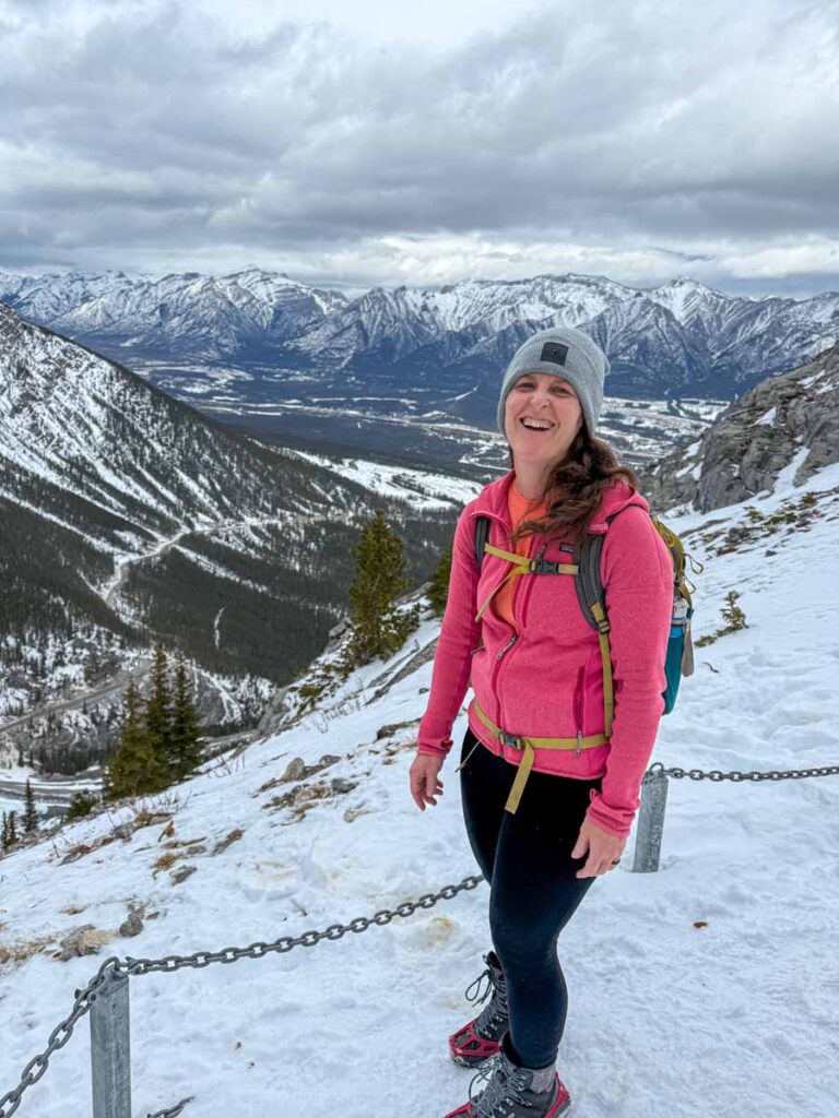 Celine Brewer enjoys a laugh while hiking Ha Ling Peak in winter.