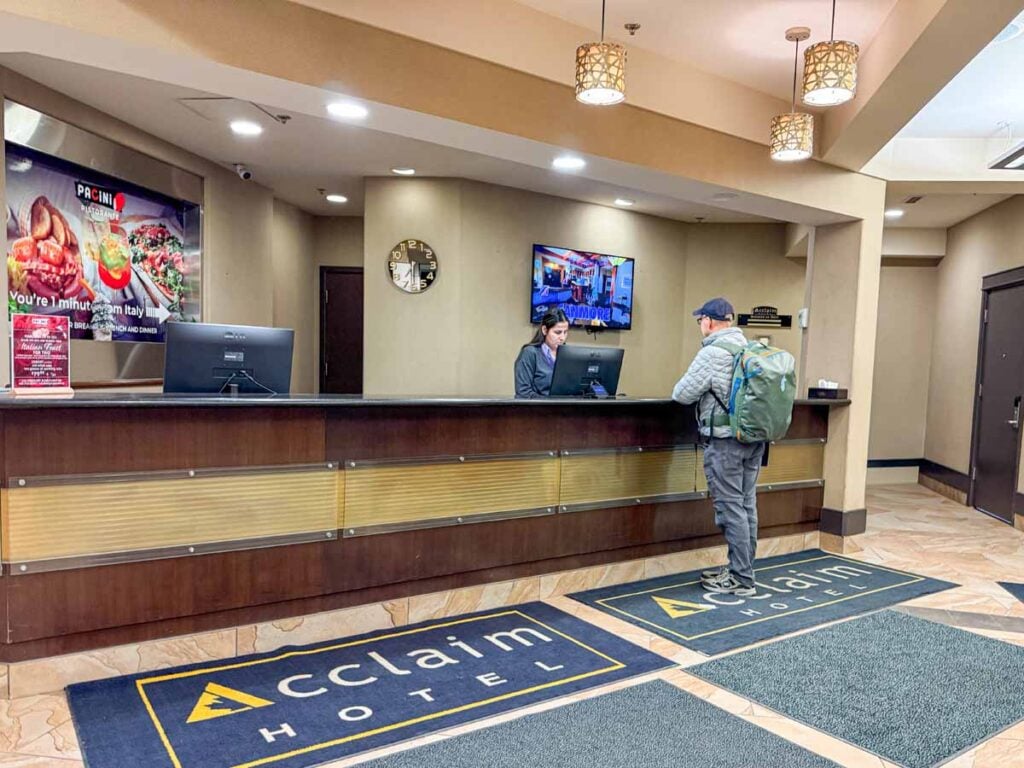 Dan Brewer, owner of TravelBanffCanada.com, checks in for a park and stay reservation at the Acclaim hotel near the Calgary Airport.