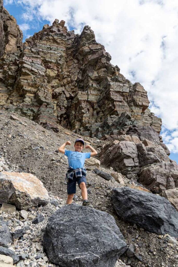 one of the Brewer kids celebrates reaching the top of the Plain of Six Glaciers hike.