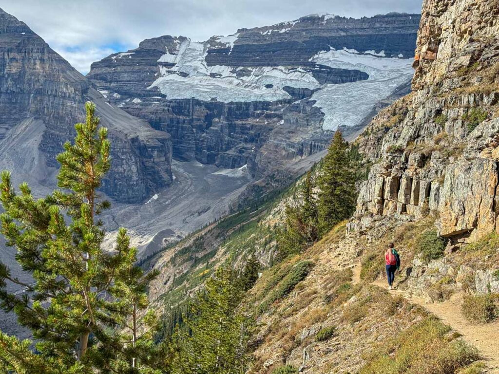 Celine Brewer hikes the Devil's Thumb Trail with sweeping Rocky Mountain views ahead.