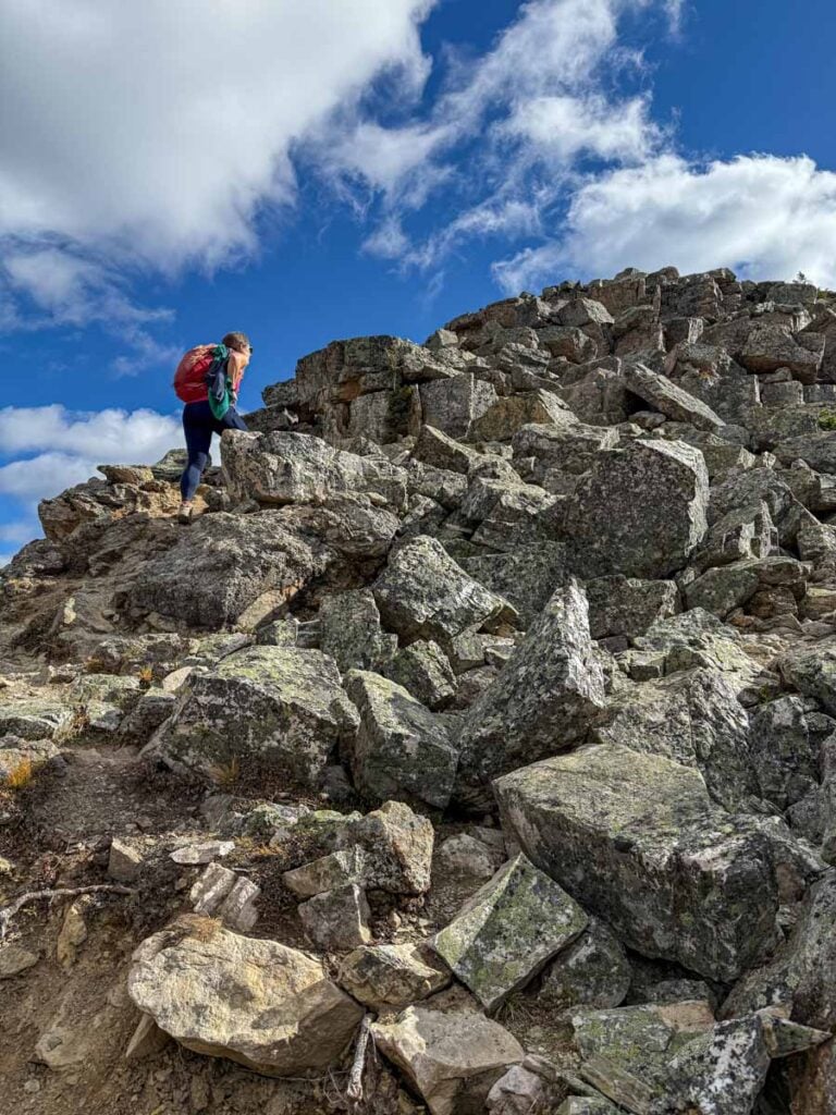 Celine Brewer hikes through a boulder field as she nears the summit of Devil's Thumb in Lake Louise, Canada.