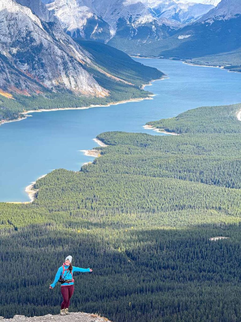Celine Brewer, host of the Banff Travel Podcast, enjoys an amazing viewpoint of the Spray Lakes Reservoir on the Tent Ridge hike.