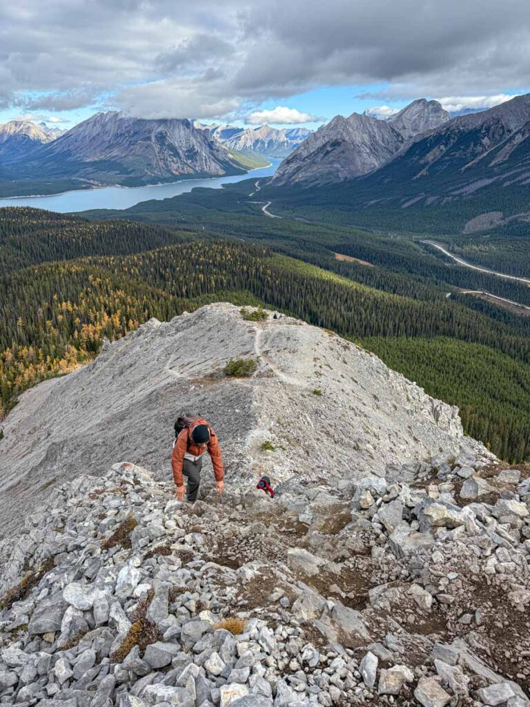 Dan Brewer hikes along a ridgeline on the Tent Ridge Horseshoe Trail with the Spray Lakes Reservoir in the background.