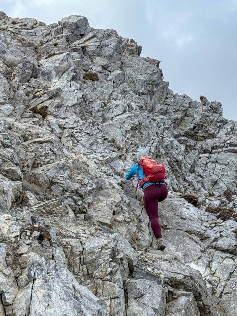 Celine Brewer, owner of TravelBanffCanada.com, climbs a steep scramble section of the Tent Ridge Trail in Kananaskis Country,
