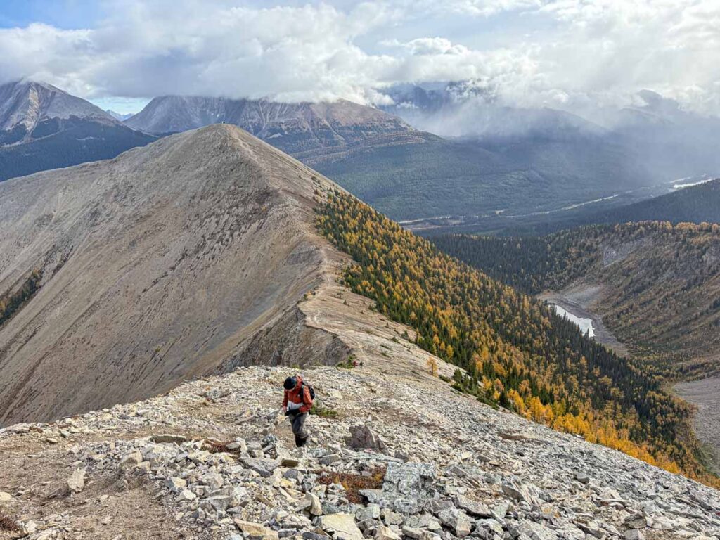 Dan Brewer, owner of the Travel Banff Canada blog, hikes through scree to reach the summit of Tent Ridge.