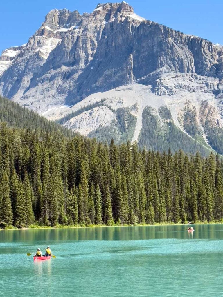 A red canoe on the water at Emerald Lake in Yoho National Park, Canada.